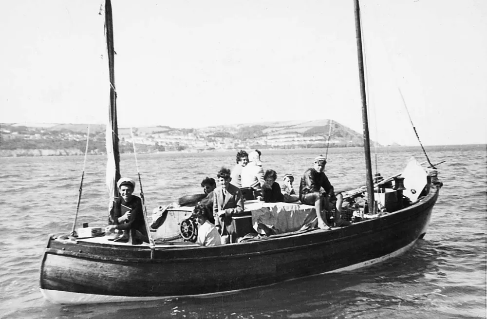 a group of people in a small boat in a body of water
